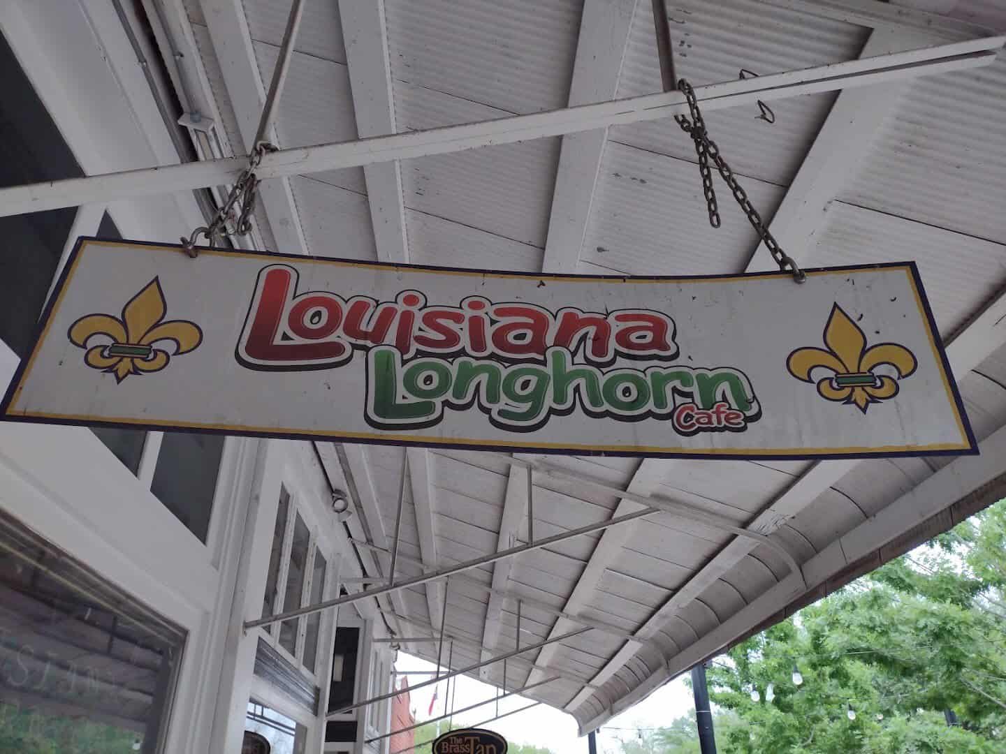Hanging Louisiana Longhorn Cafe sign with fleur-de-lis in downtown Round Rock, Texas
