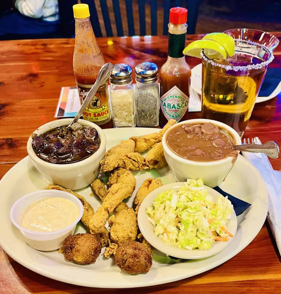 Golden fried Cajun platter with red beans, slaw and hush puppies at Louisiana Longhorn Cafe in Round Rock, Texas