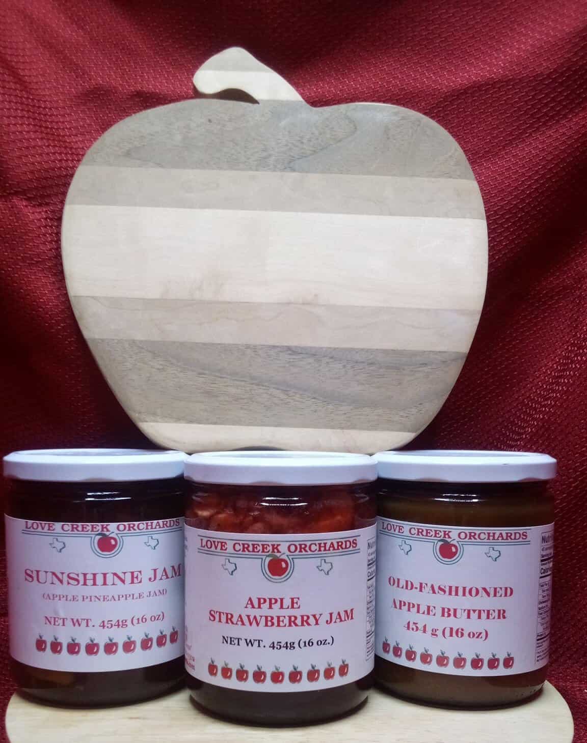 Apple butter and jam jars on an apple-shaped board at Love Creek Orchards in Medina, Texas