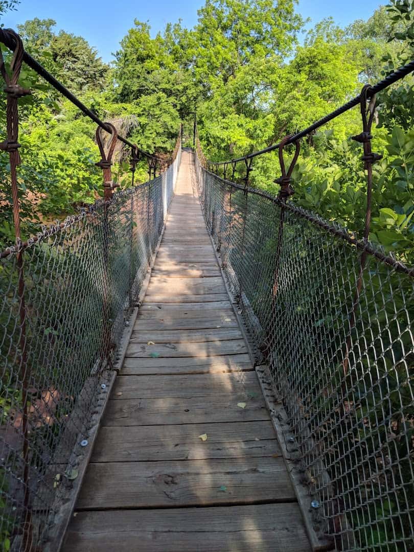 Swinging suspension bridge over the Wichita River at Lucy Park in Wichita Falls, Texas