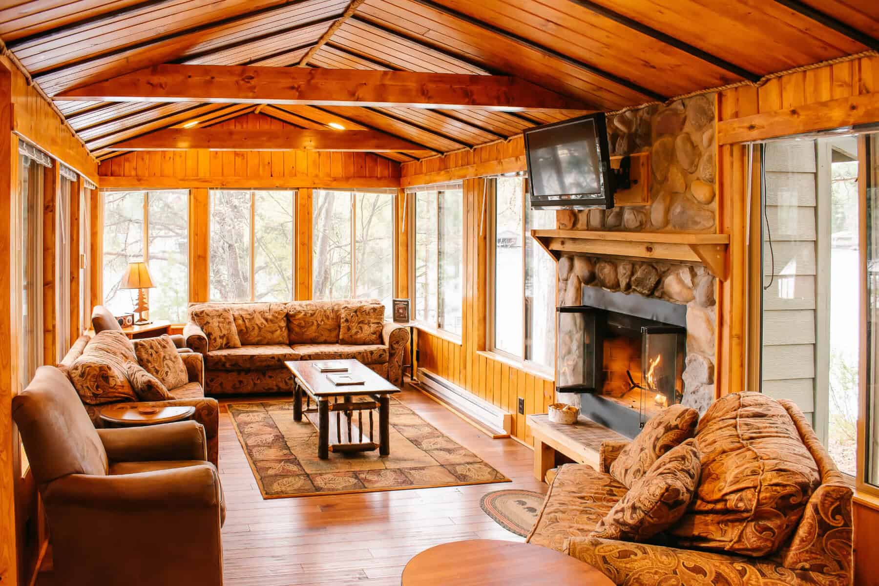 Log cabin interior with stone fireplace at Ludlow's Island Resort on Lake Vermilion, Minnesota