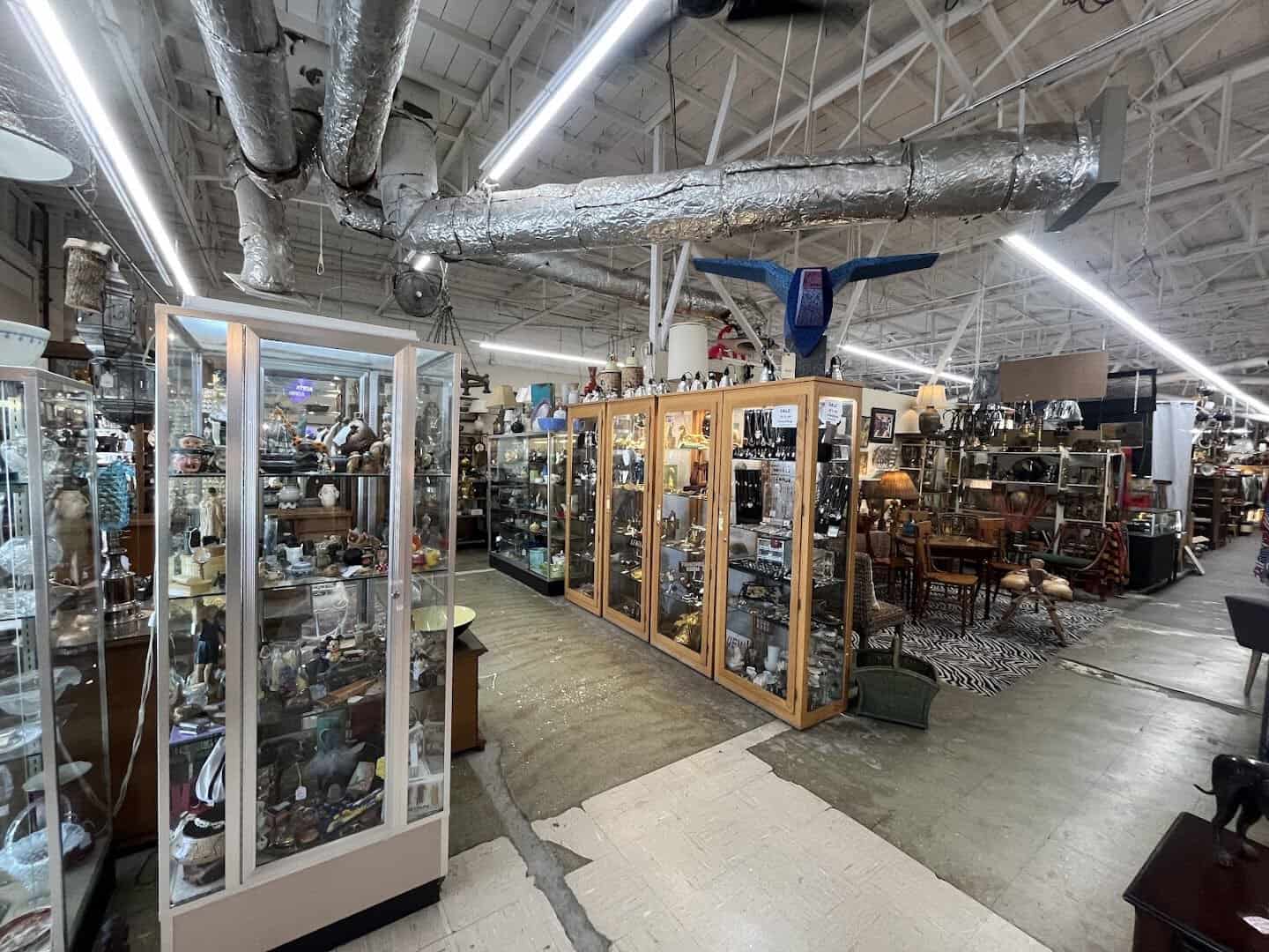 A wide aisle packed with antiques and collectibles at Lula B's Design District in Dallas