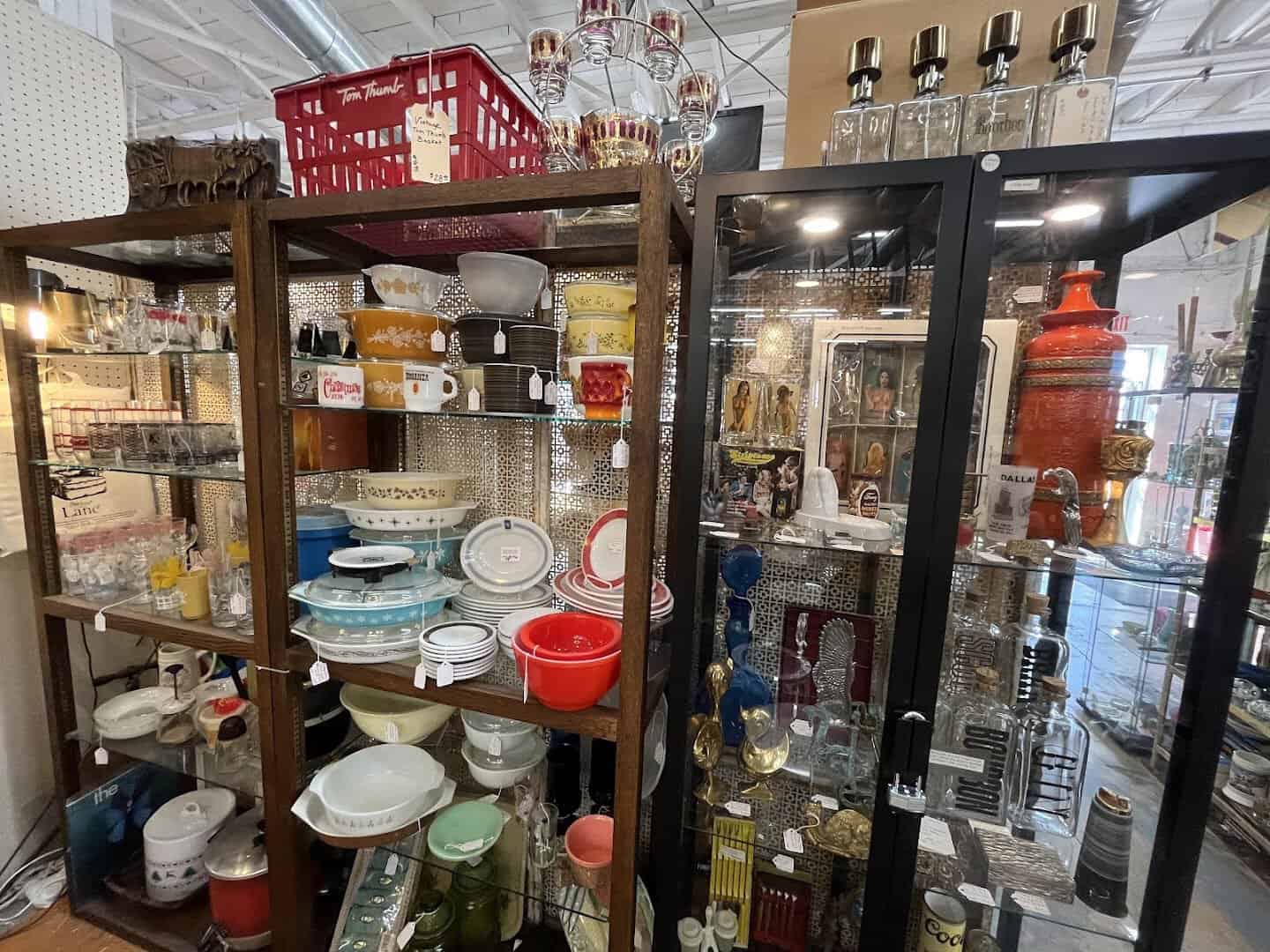 Glass cases filled with vintage glassware at Lula B's Design District in Dallas
