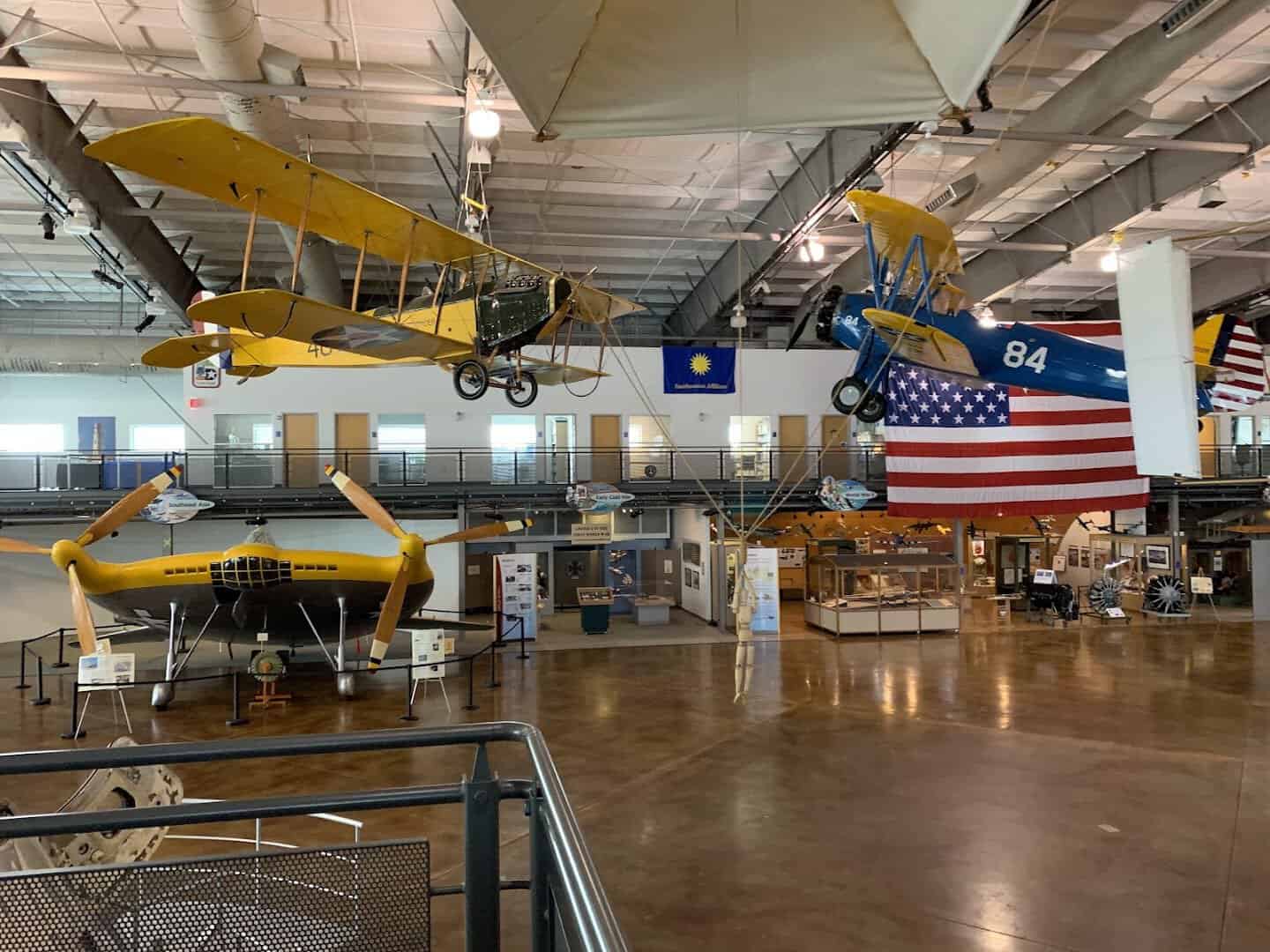 Historic aircraft and flags fill the main hall at the Frontiers of Flight Museum in Dallas