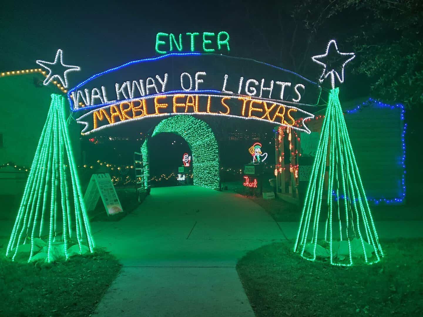 Illuminated Walkway of Lights entrance archway at night in Marble Falls, Texas