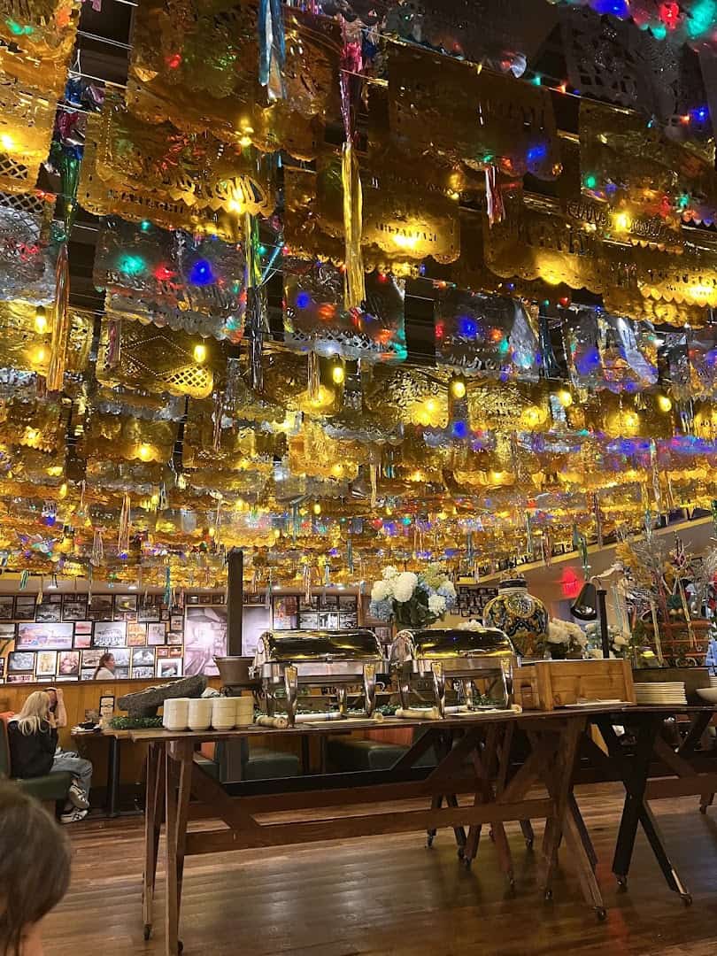The bar glowing under string lights at Mi Familia at the Rim in San Antonio