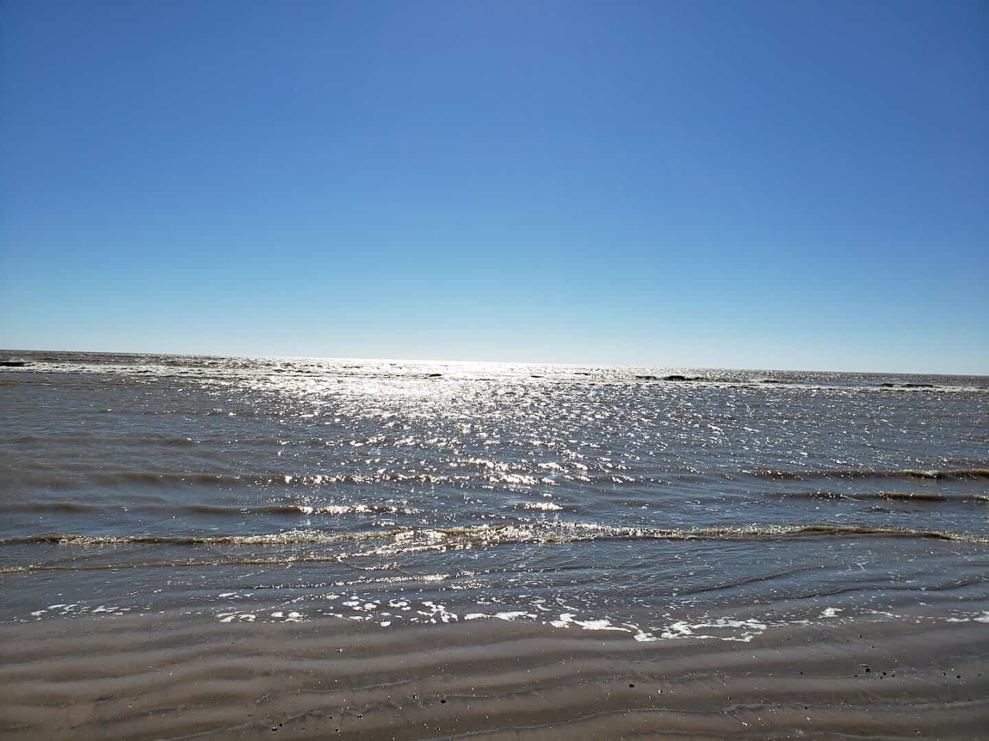 Sunlit Gulf shoreline at McFaddin National Wildlife Refuge near Sabine Pass, Texas