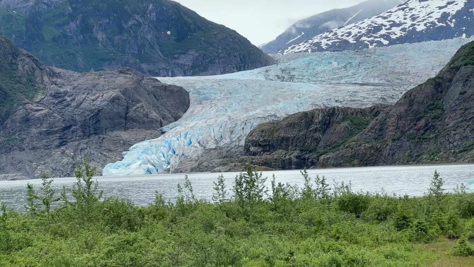 The Mendenhall Glacier flowing between mountains near Juneau, Alaska