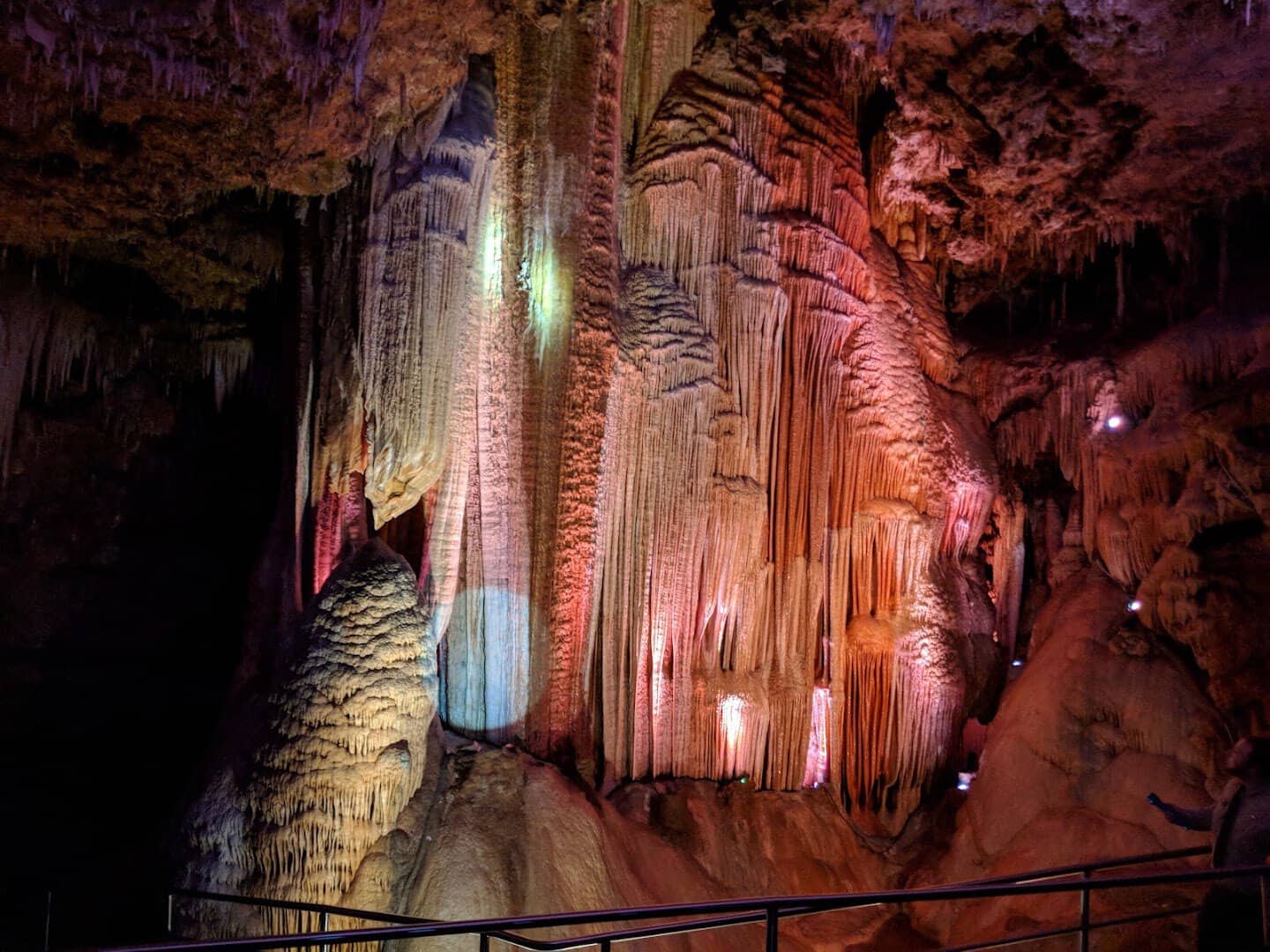 Colorfully lit stone formations inside Meramec Caverns, Missouri