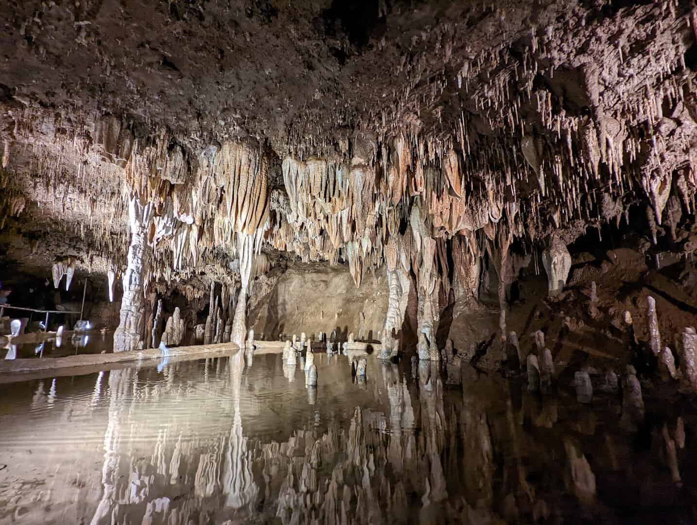 Underground pool reflecting cave formations in Meramec Caverns, Missouri