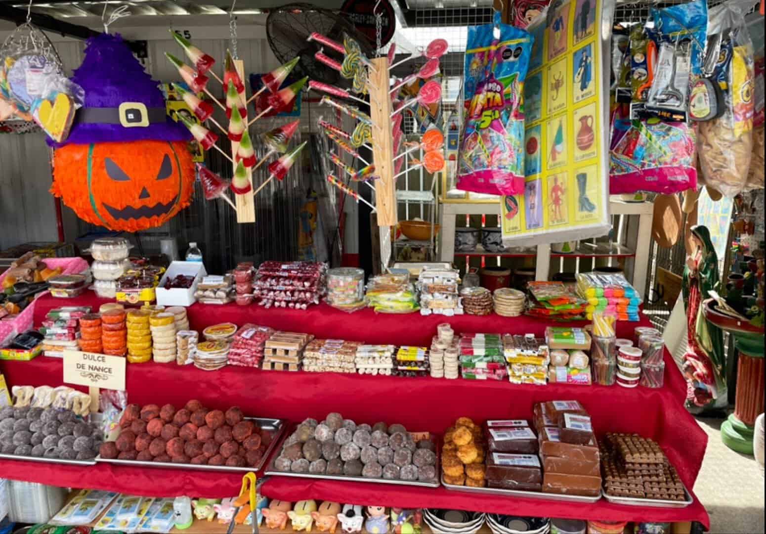 A stall of Mexican candy and dulces under a Halloween pinata at Cole's flea market in Pearland, Texas