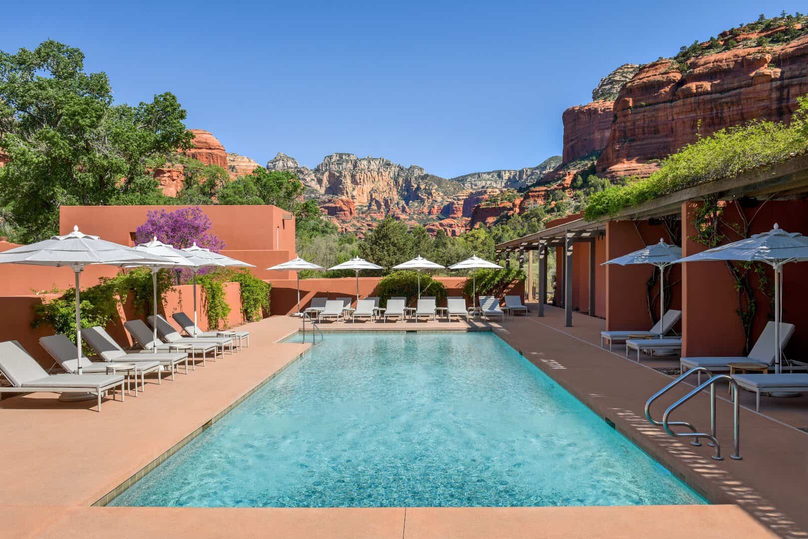 Resort pool framed by red rock cliffs at Mii amo in Sedona, Arizona