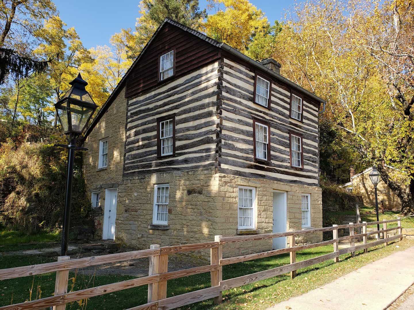 Historic Cornish log cabin with fall foliage at Pendarvis in Mineral Point, Wisconsin