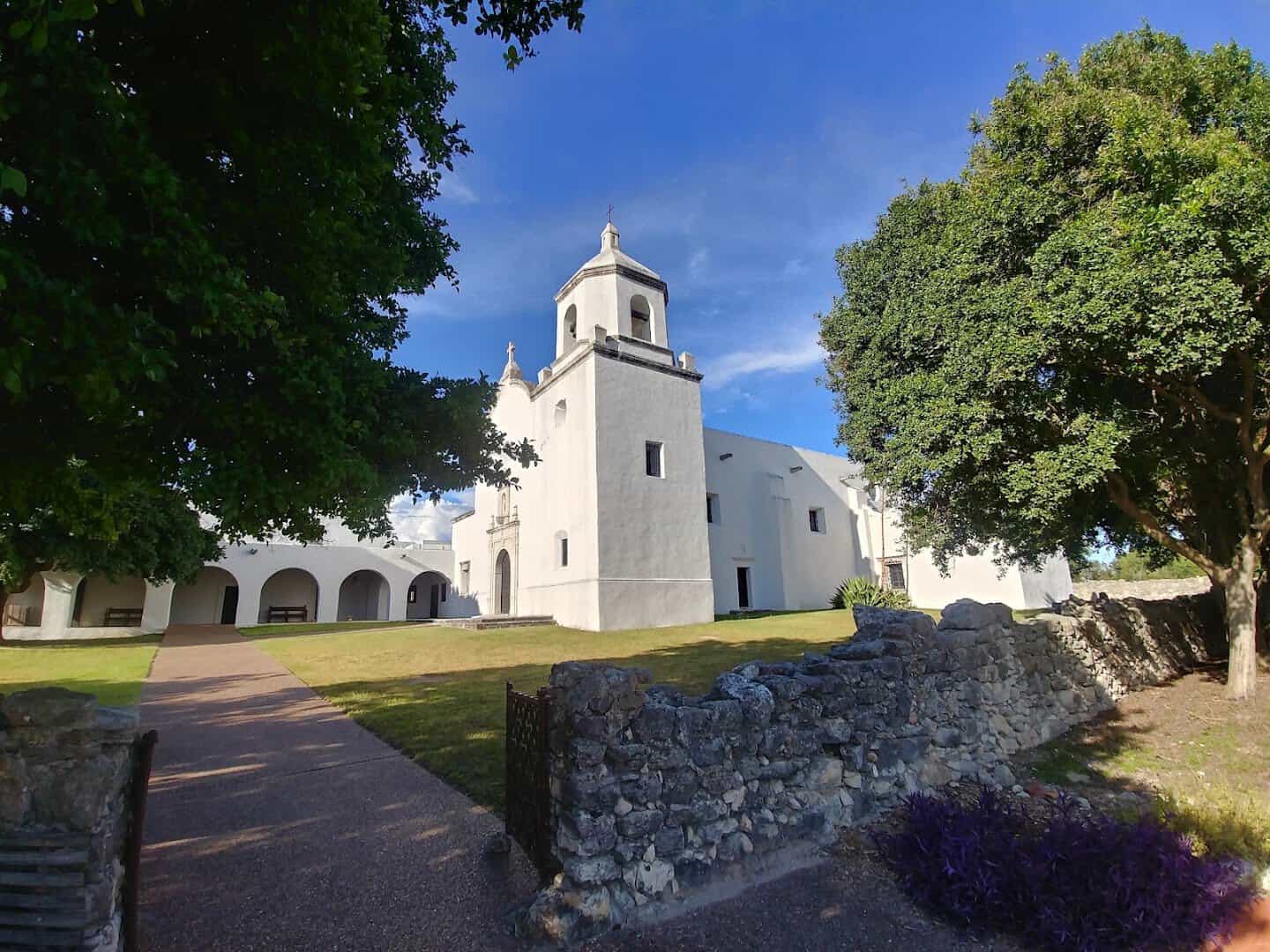 Mission Espiritu Santo church and arched cloister walkway at Goliad State Park, Texas