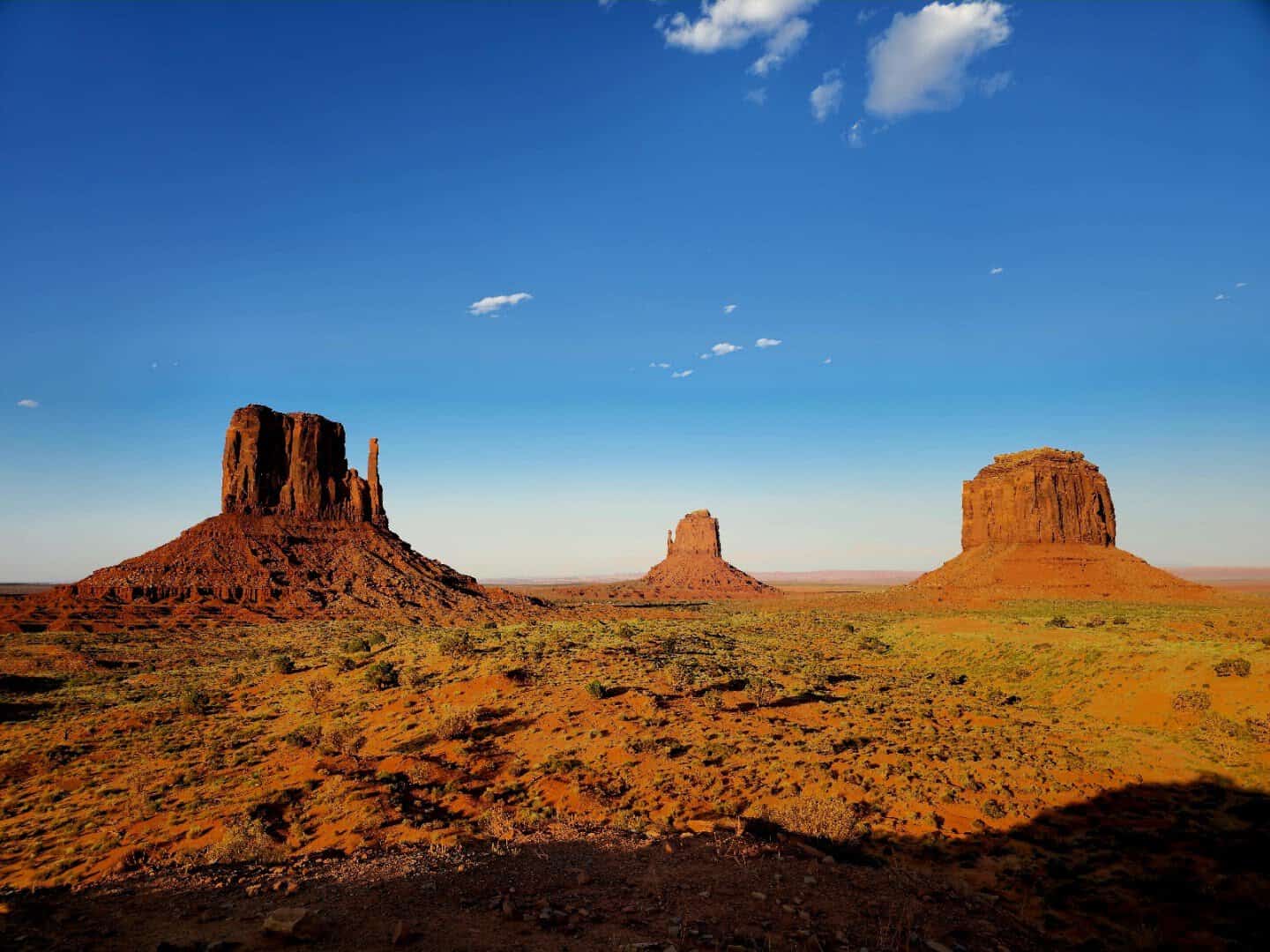 Red sandstone buttes rising over the desert at Monument Valley, Arizona