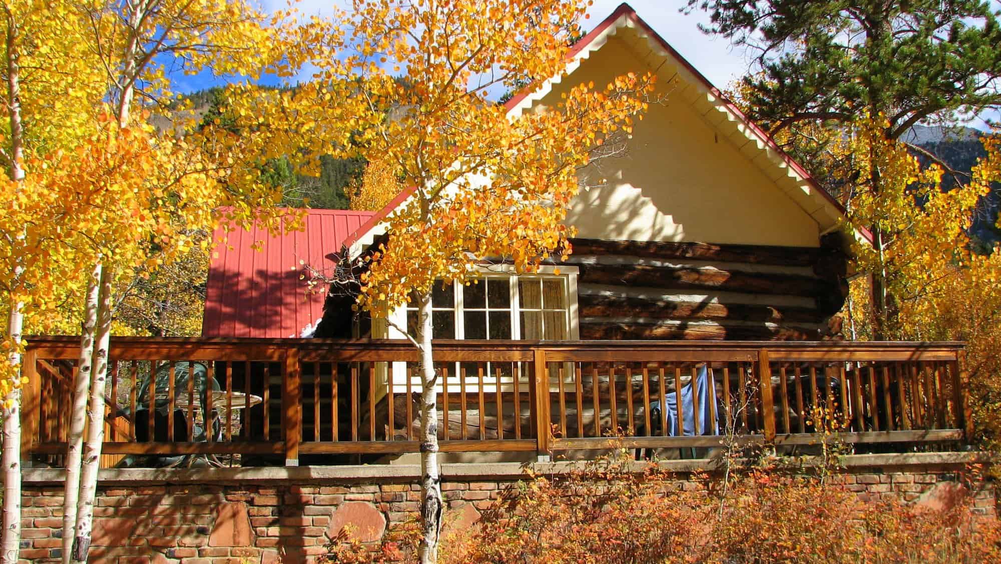 Log cabin among fall aspens at Mount Elbert Lodge in Twin Lakes, Colorado