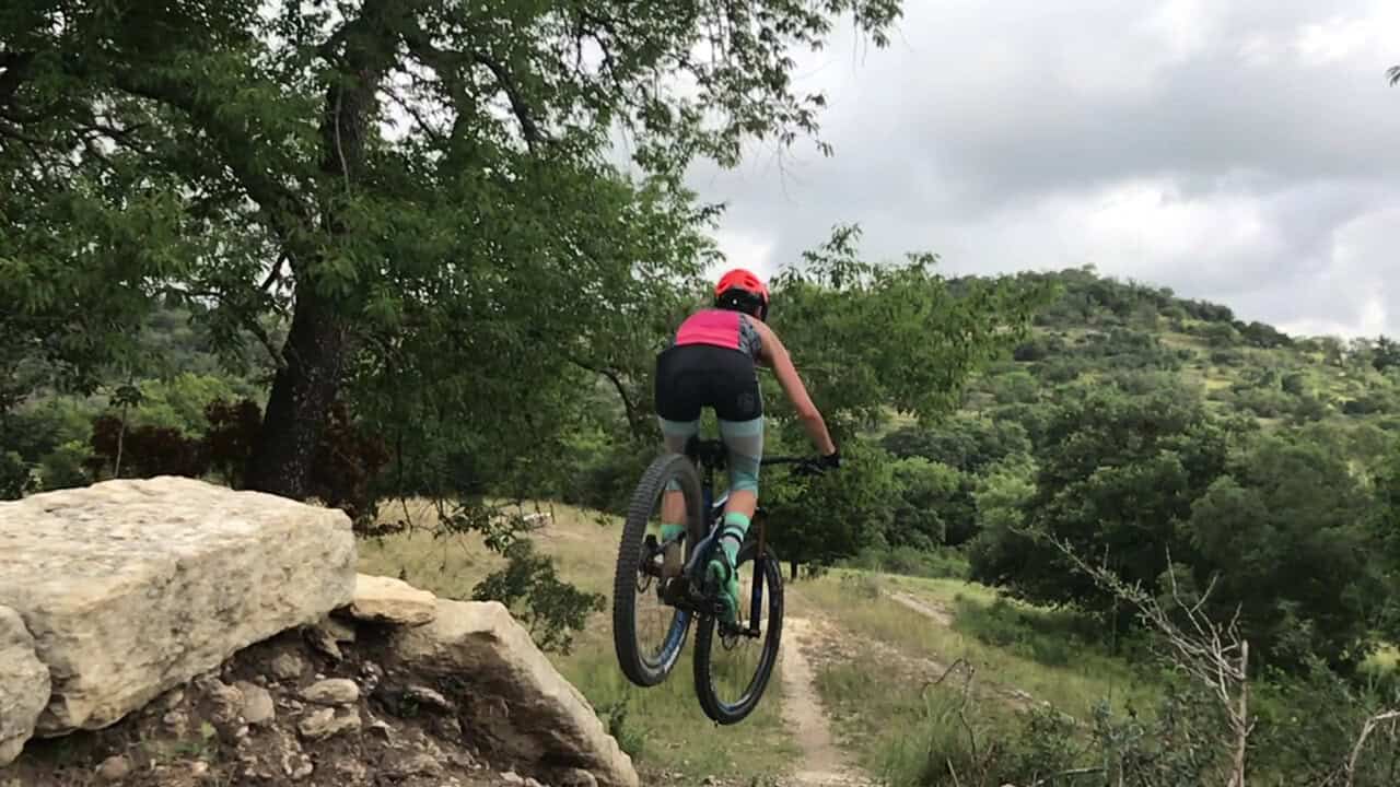 Mountain biker riding a rugged singletrack trail at Flat Rock Ranch in Comfort, Texas