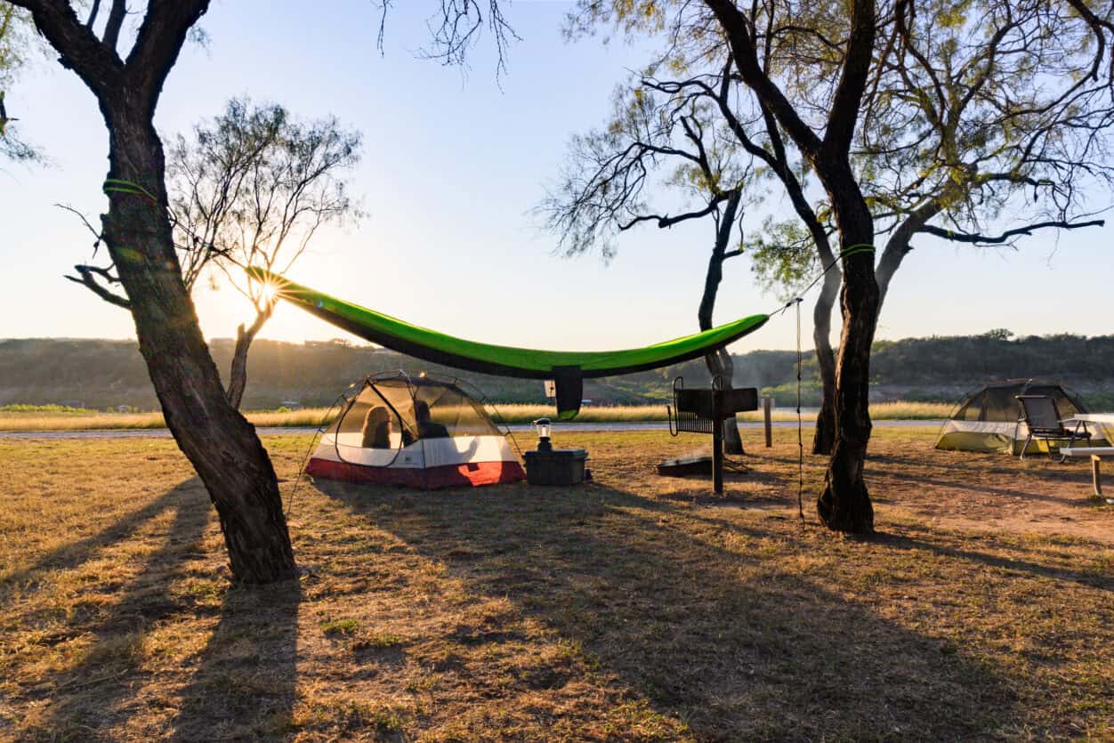 Hammock and tent campsite at sunrise beside the water at Muleshoe Bend Recreation Area