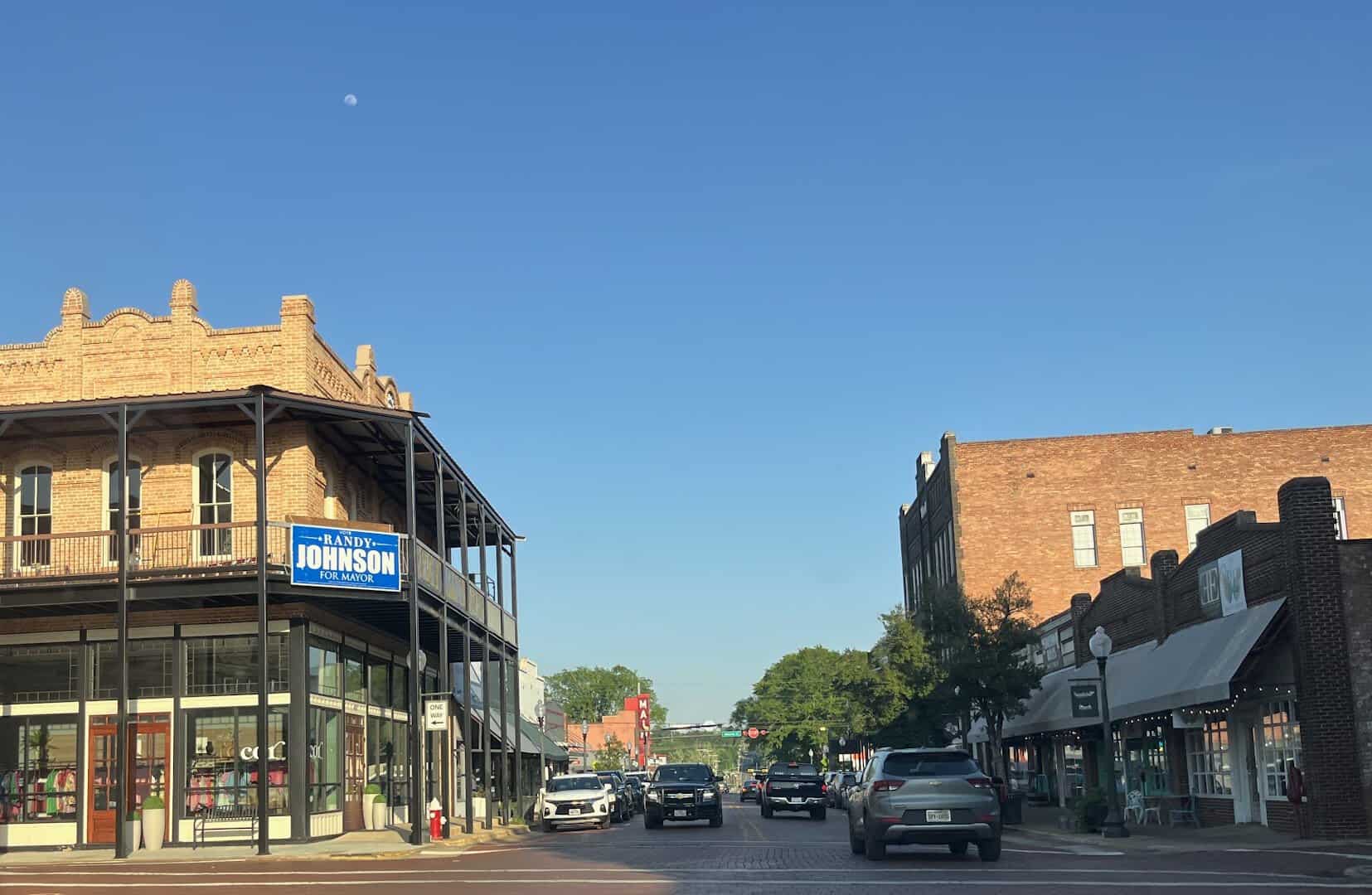 Red brick street lined with historic buildings in downtown Nacogdoches, Texas