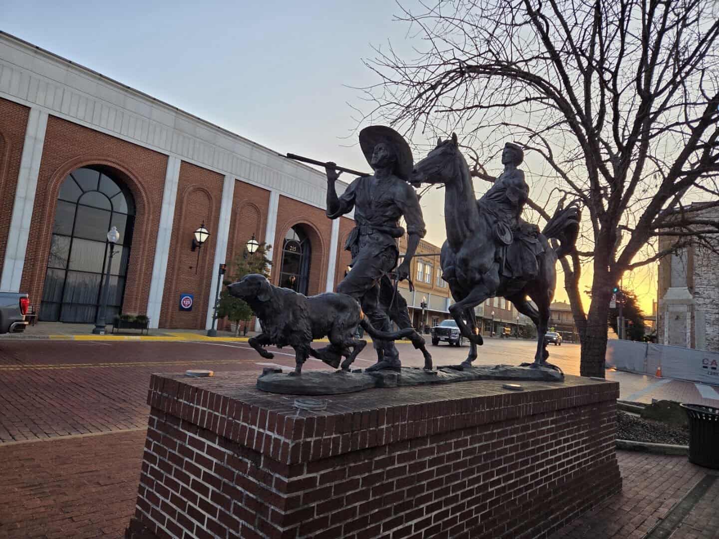 Bronze statue on a brick plaza along the Nacogdoches Statue Trail in Texas