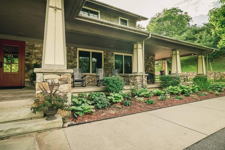 Stone lodge with rocking chairs on the porch at Nantahala Village in Bryson City, North Carolina