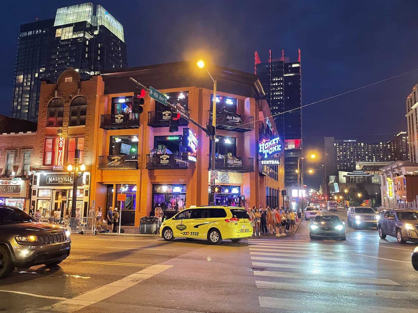 Neon honky-tonk bars along Broadway at dusk in Nashville, Tennessee