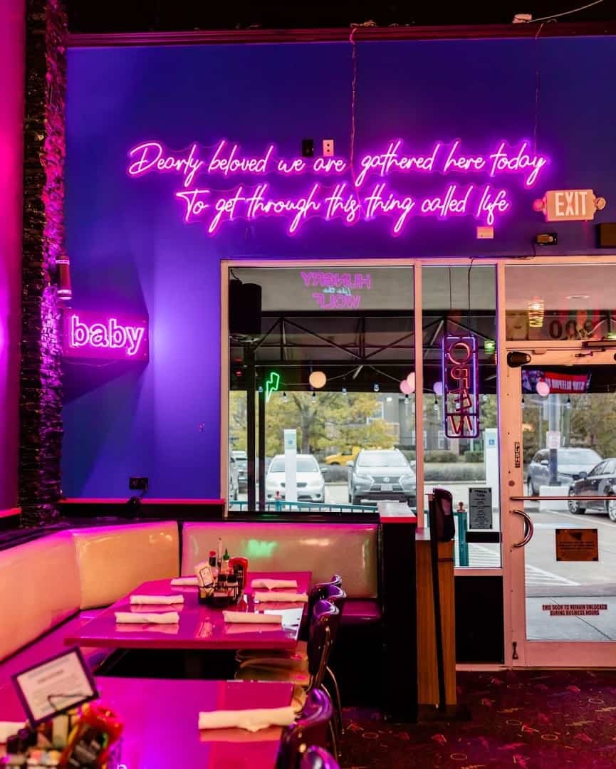 Neon-lit booth and signage at Hungry Like The Wolf in Houston