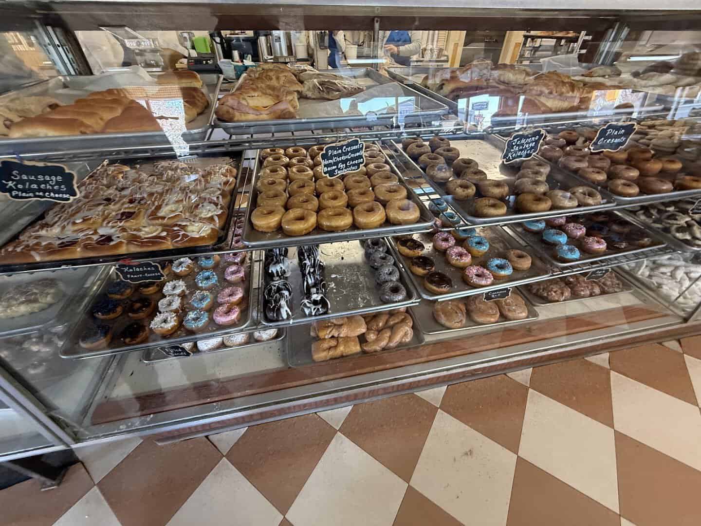 Trays of fresh doughnuts and pastries in the cases at Newman's Bakery in Bellville, Texas