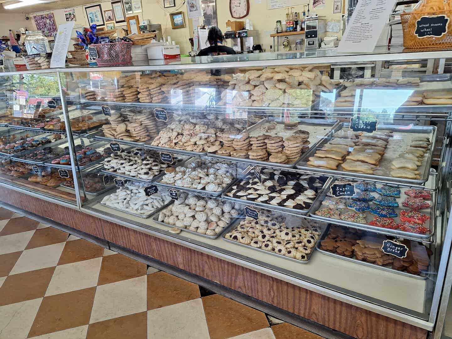 Glass display case full of pastries and cookies at Newman's Bakery in Bellville, Texas