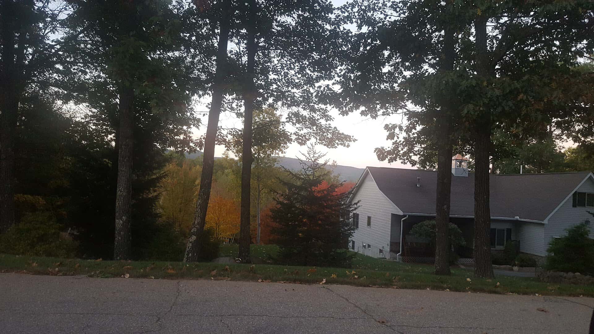 A house framed by autumn maples in North Conway, New Hampshire
