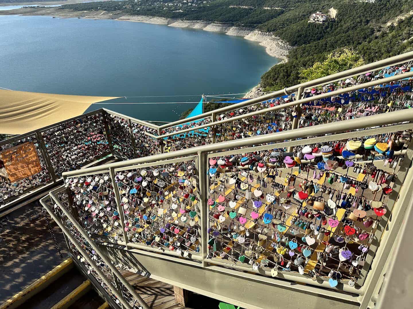 Love locks clipped to a deck railing at The Oasis on Lake Travis in Austin