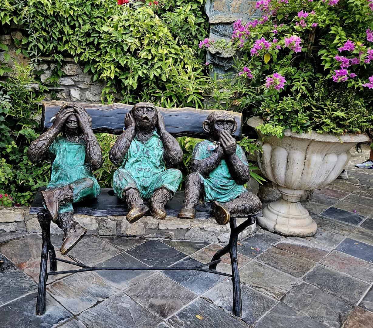 Bronze see-no-evil monkey statues at The Oasis on Lake Travis in Austin