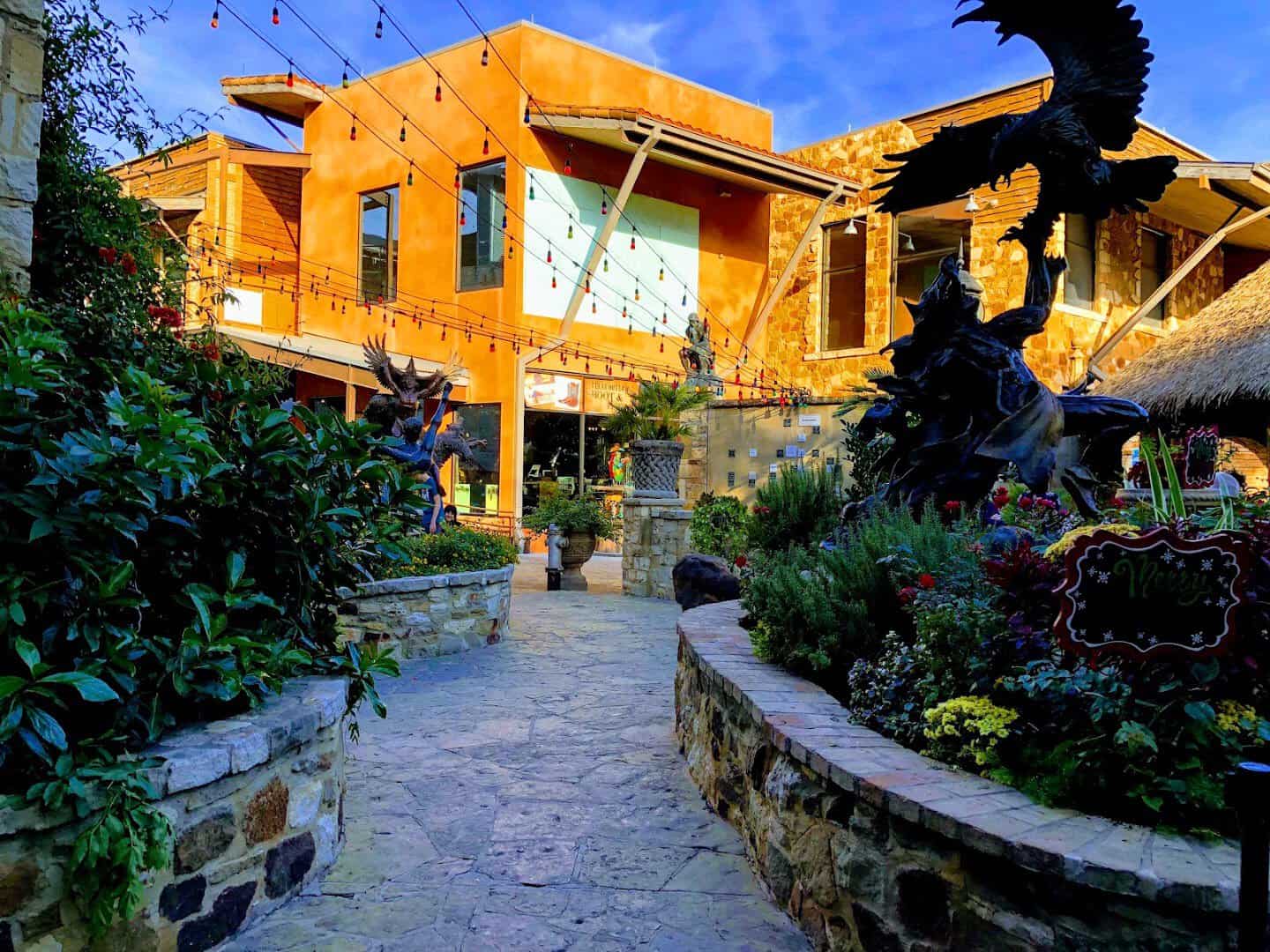 Warm evening light on the stone terraces and gardens of The Oasis on Lake Travis in Austin
