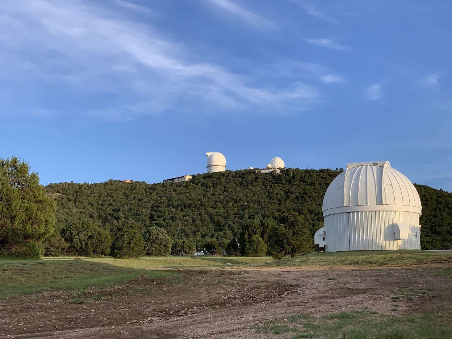 White observatory domes on a remote ridge at McDonald Observatory in West Texas