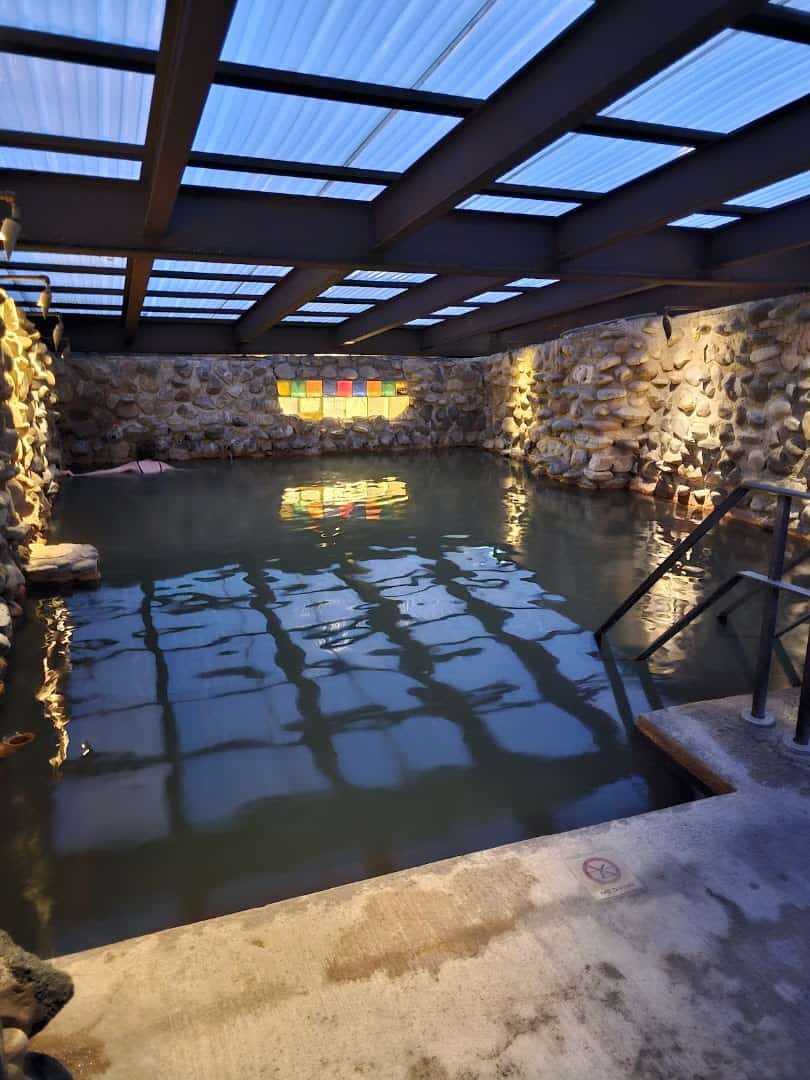 Candlelit indoor mineral soaking pool at Ojo Caliente Mineral Springs Resort, New Mexico