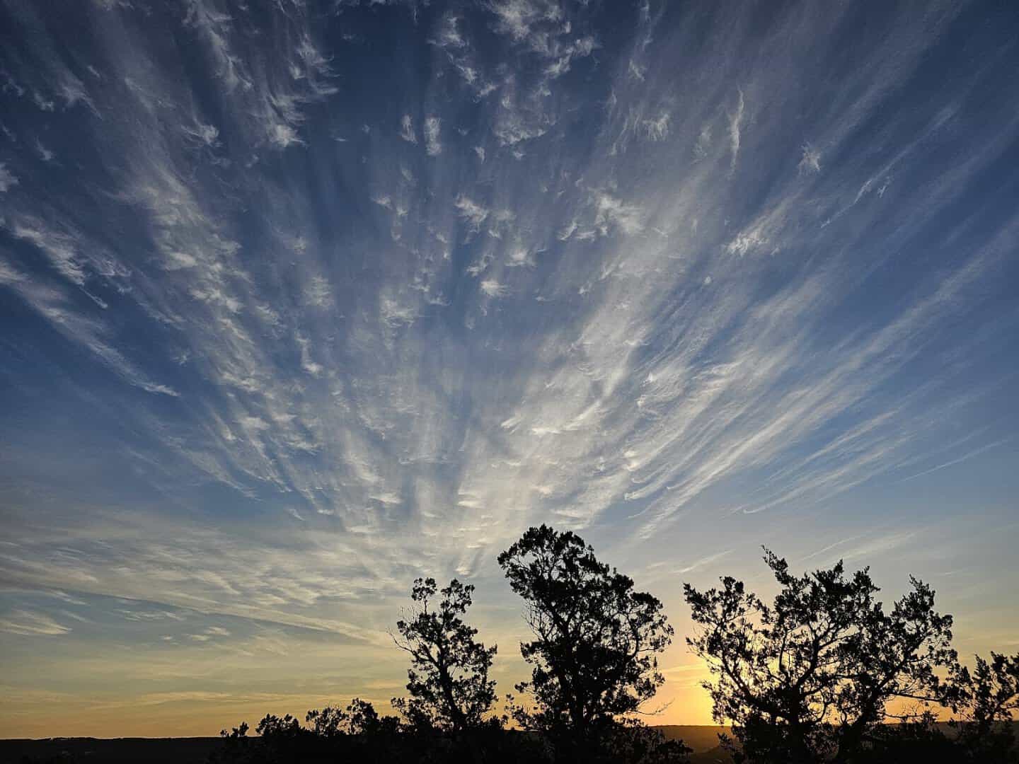 Sunset light and dramatic sky over the Hill Country from Old Baldy summit