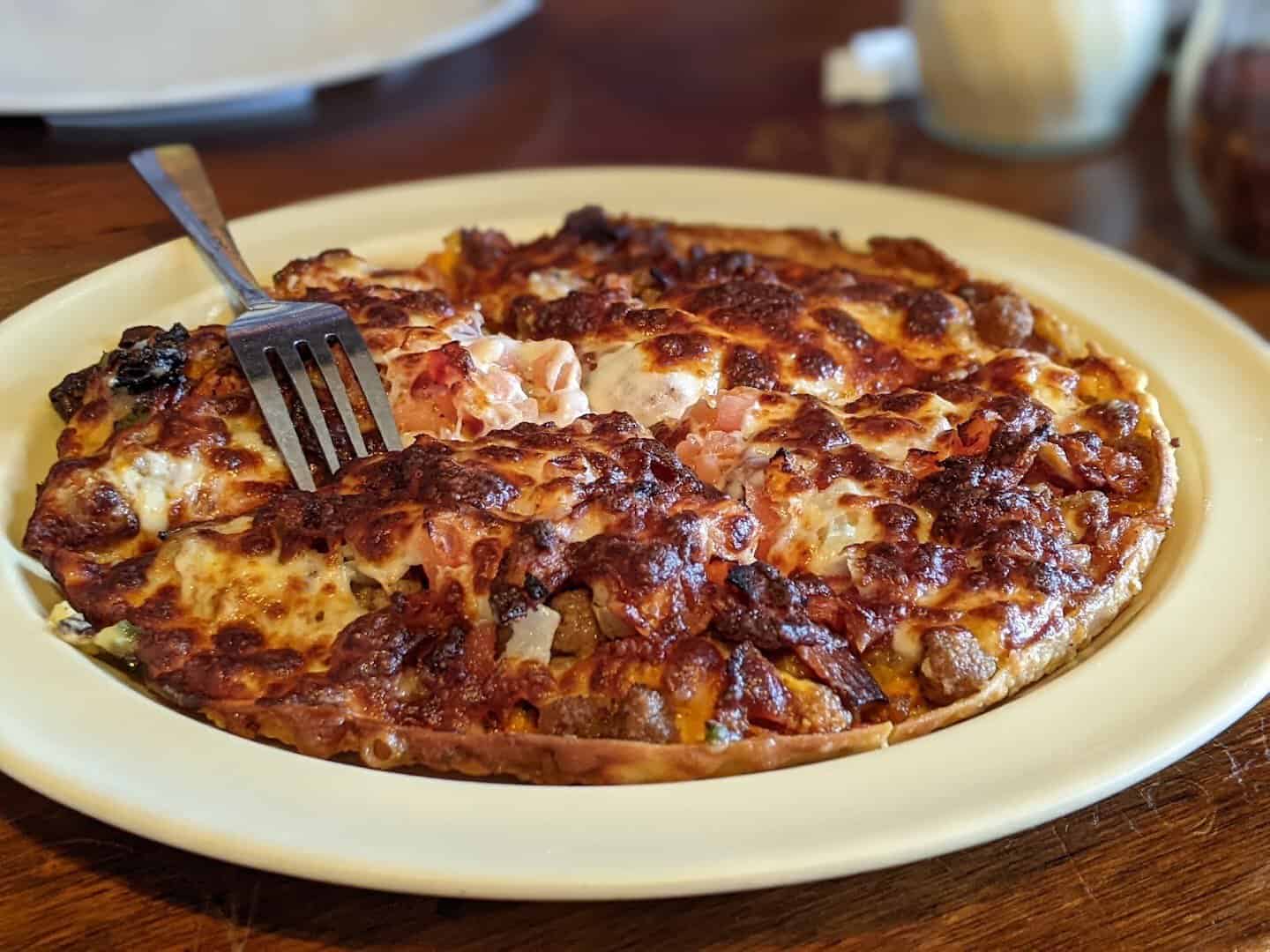 A saucy pan pizza at Old School Pizza Tavern in Arlington, Texas