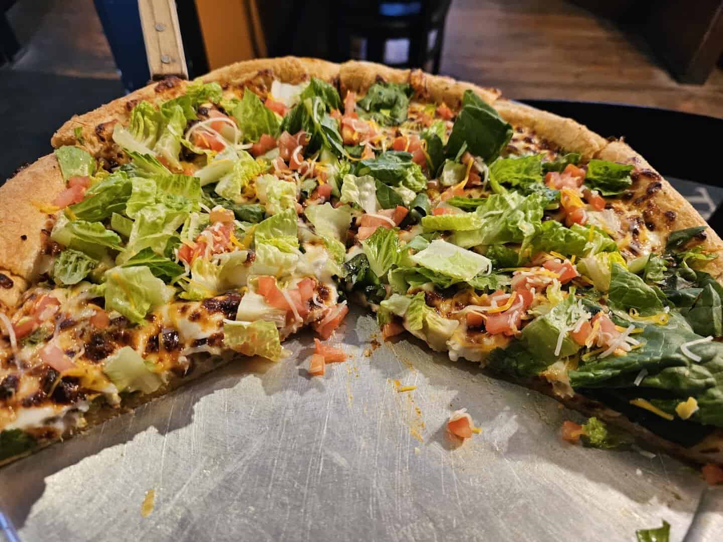A loaded veggie pizza slice at Old School Pizza Tavern in Arlington, Texas