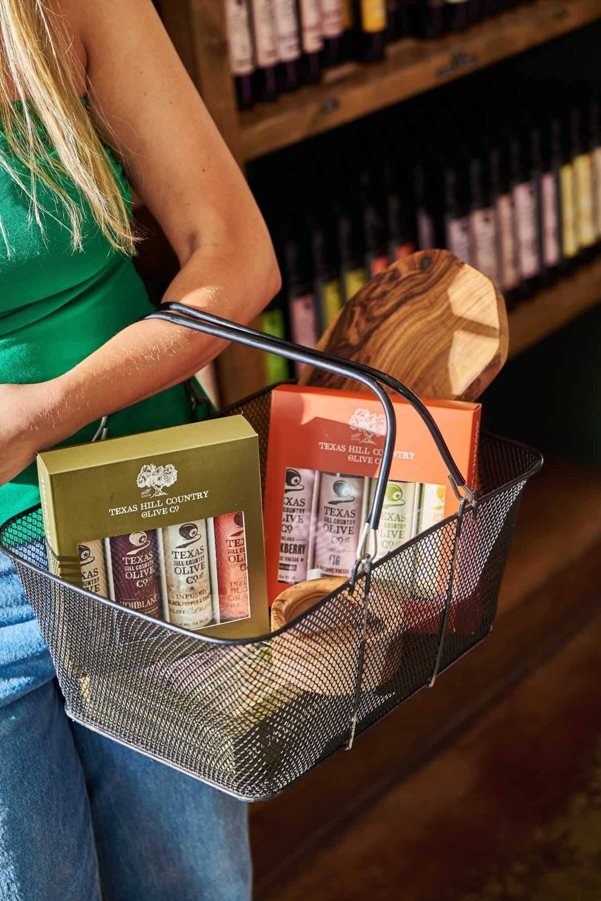 Shopping basket of olive oil gift sets in the gourmet shop at Texas Hill Country Olive Co.