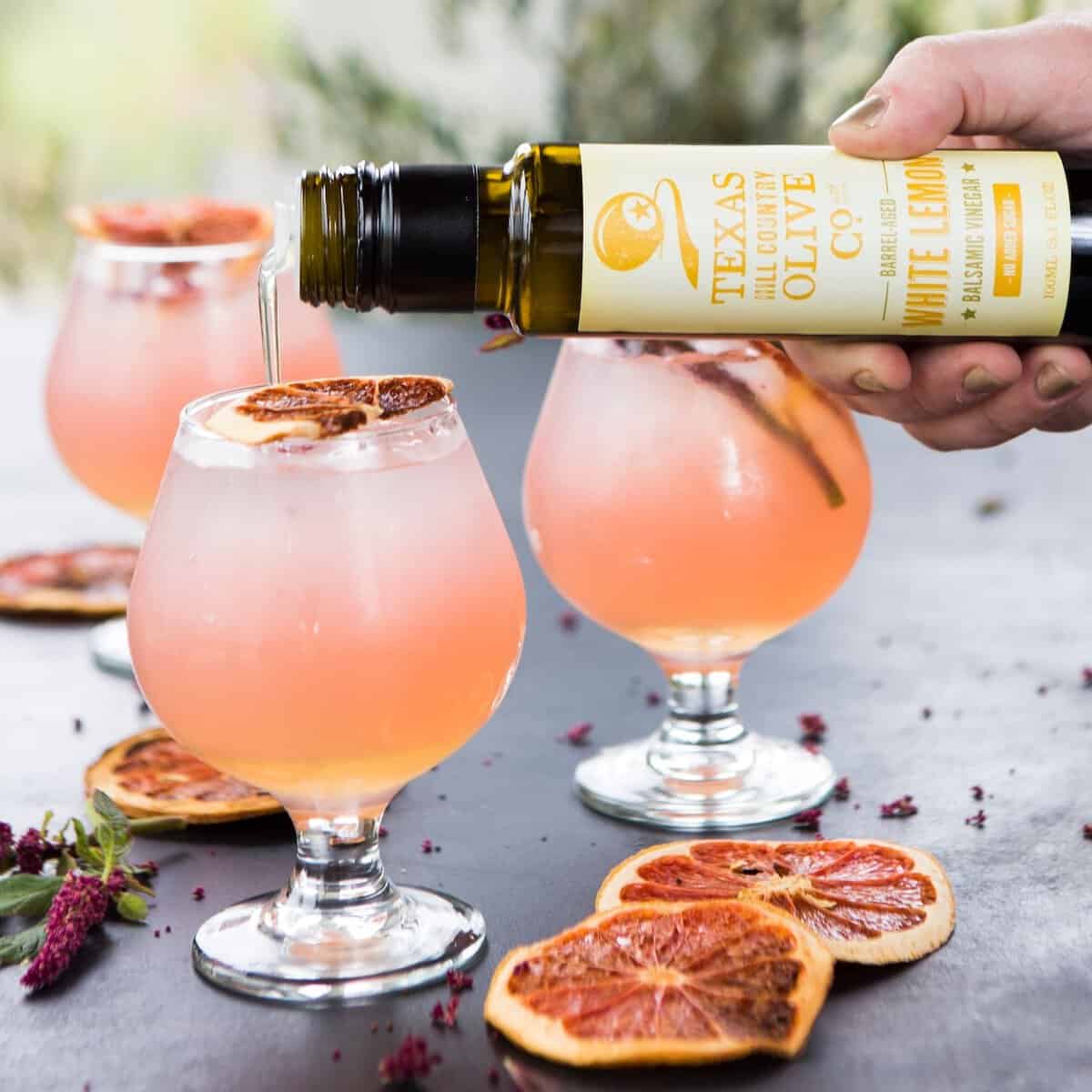 Pink spritz cocktails made with Texas Hill Country Olive Co. white lemon balsamic