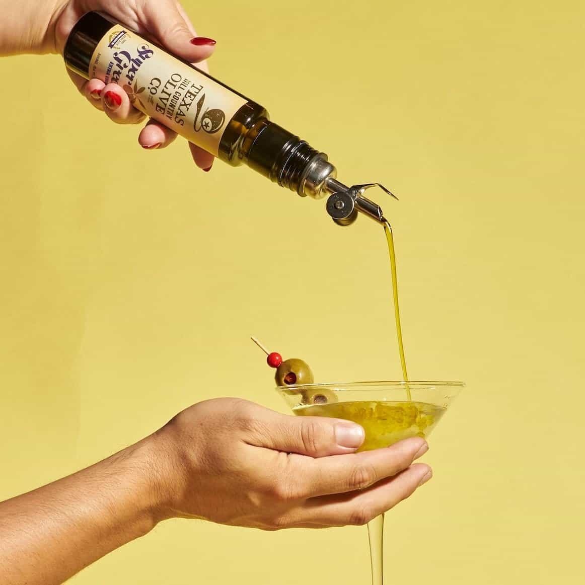 Texas Hill Country Olive Co. extra virgin olive oil poured into a glass