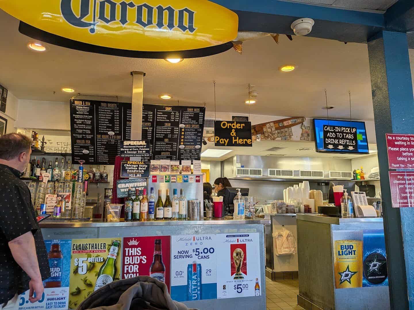 Order counter with signed dollar bills stapled to the beam at Fish Shack in Plano, Texas