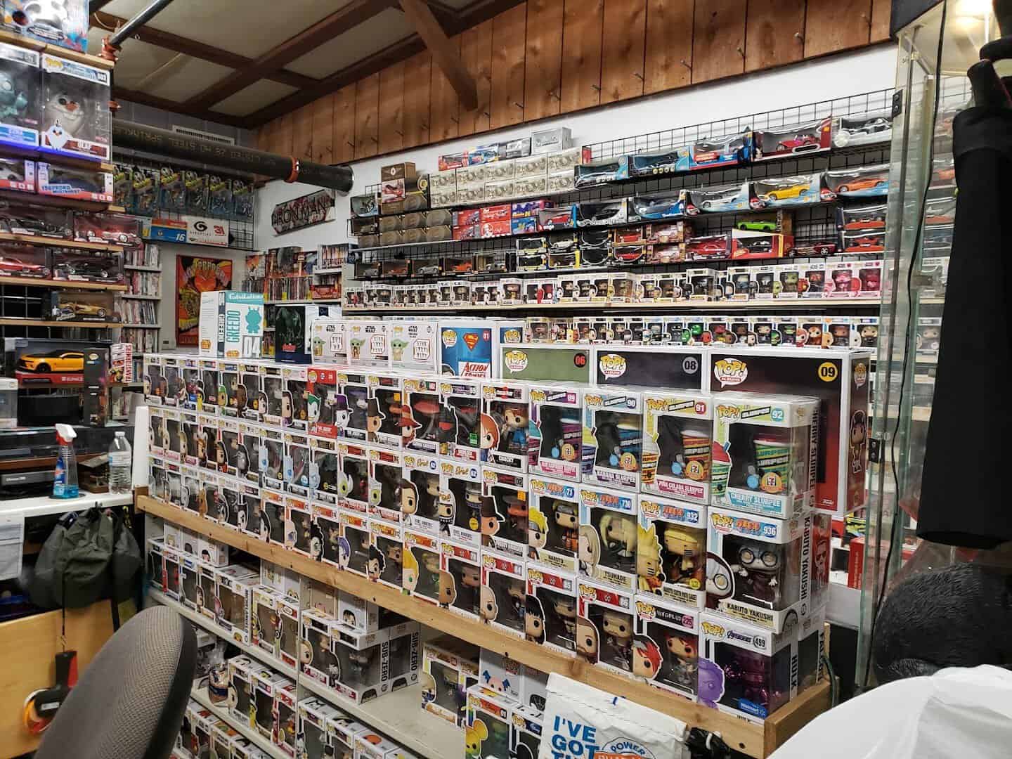 Shelves of boxed collectibles filling a vendor booth at Cole's Antique Village in Pearland, Texas