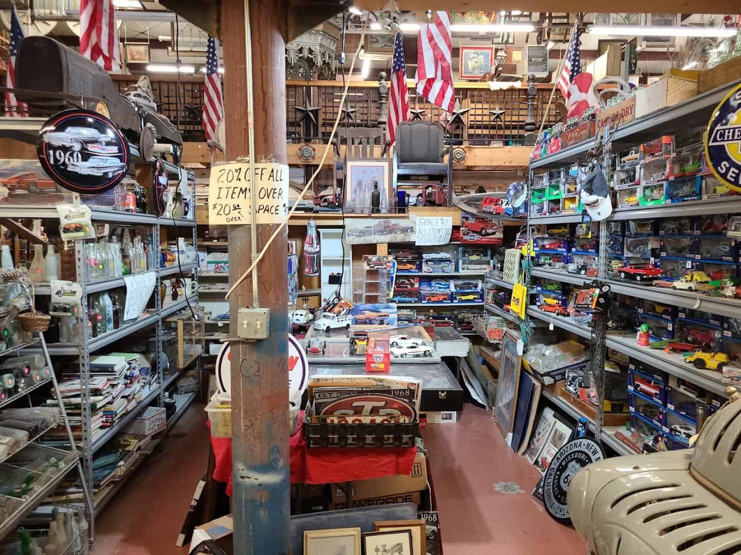 A packed booth aisle of antiques and collectibles inside The Whoopee Bowl Antique Mall in Canutillo, Texas