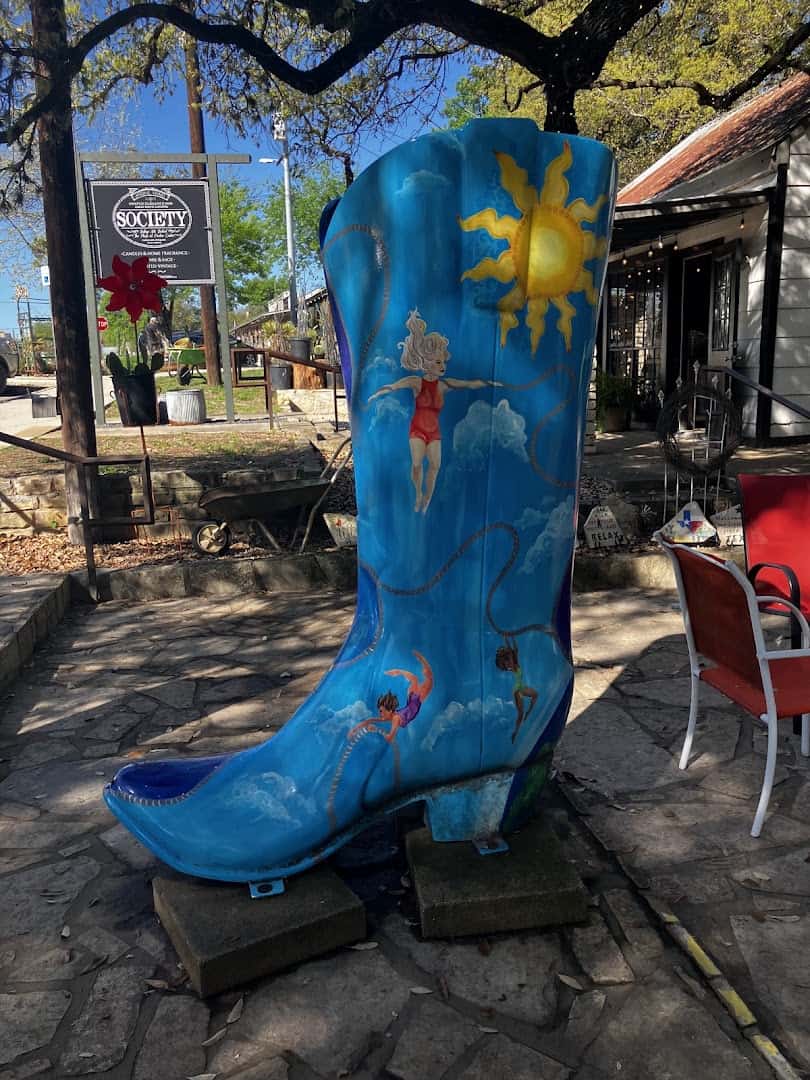Giant painted cowboy boot yard art at Wimberley Market Days in Wimberley, Texas