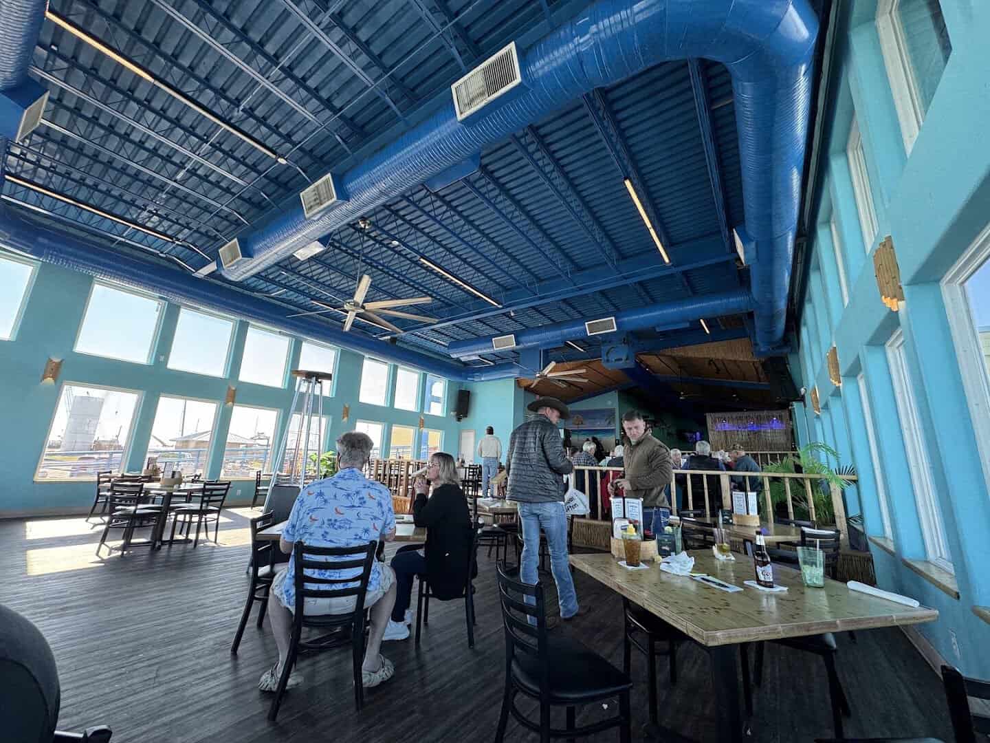 Panoramic indoor dining room with bay views at Paradise Key in Rockport, Texas