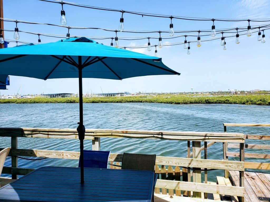 Dockside deck with umbrella overlooking Aransas Bay at Paradise Key in Rockport, Texas