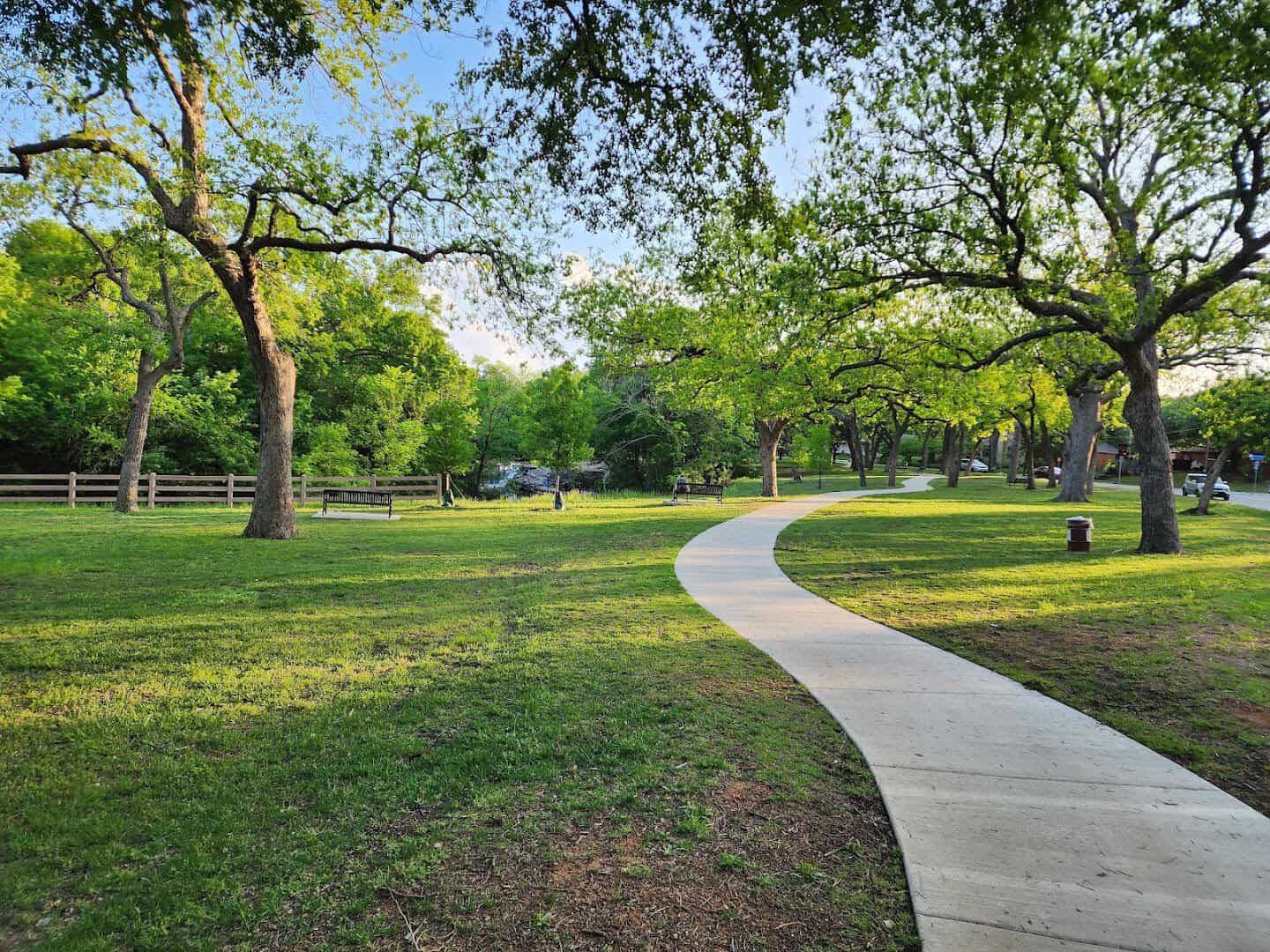 Paved path leading into Prairie Creek Park in Richardson, Texas