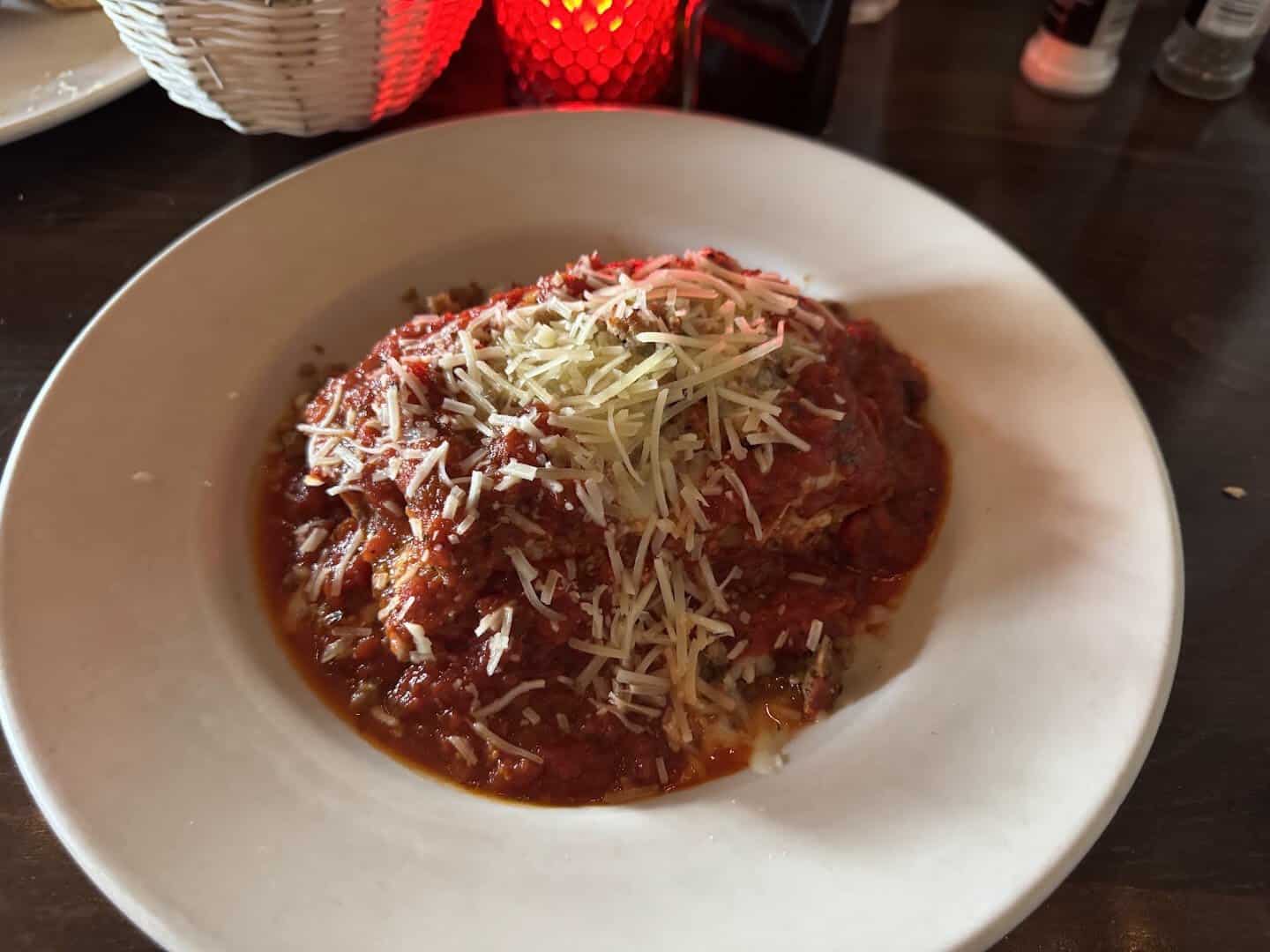 Baked parmigiana in red sauce with melted cheese at Roman Cucina in Dallas
