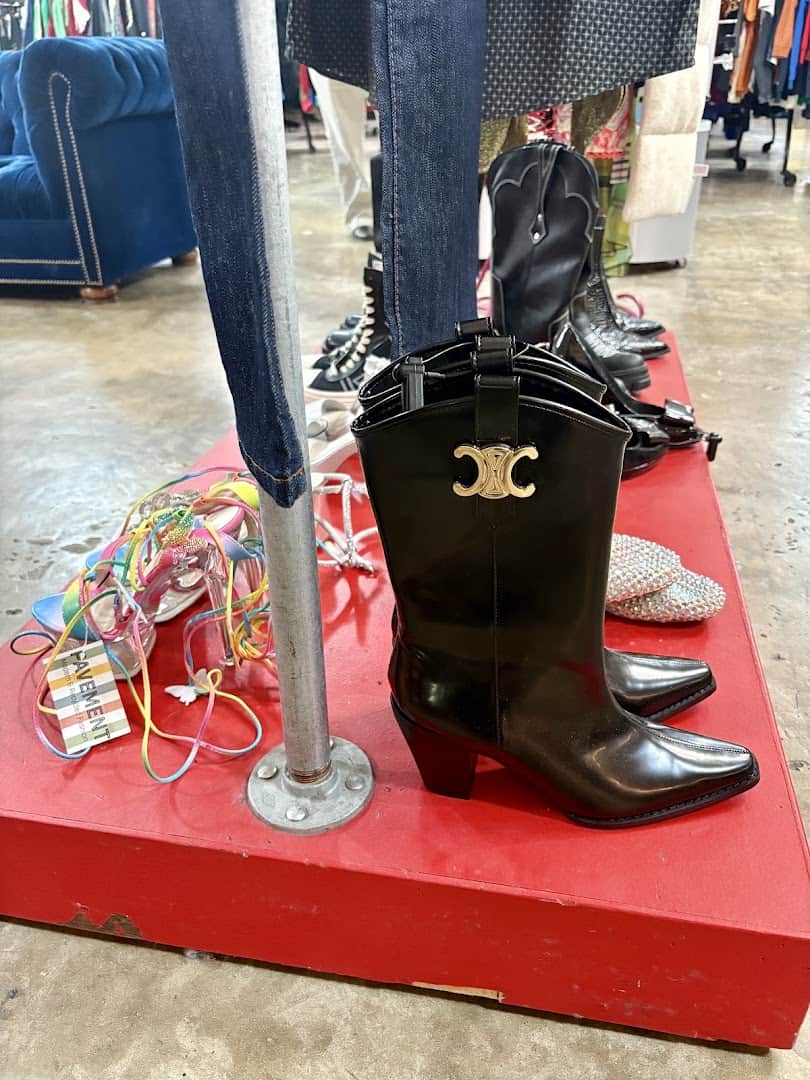 Metallic designer cowboy boots on a display pedestal at Pavement in Austin
